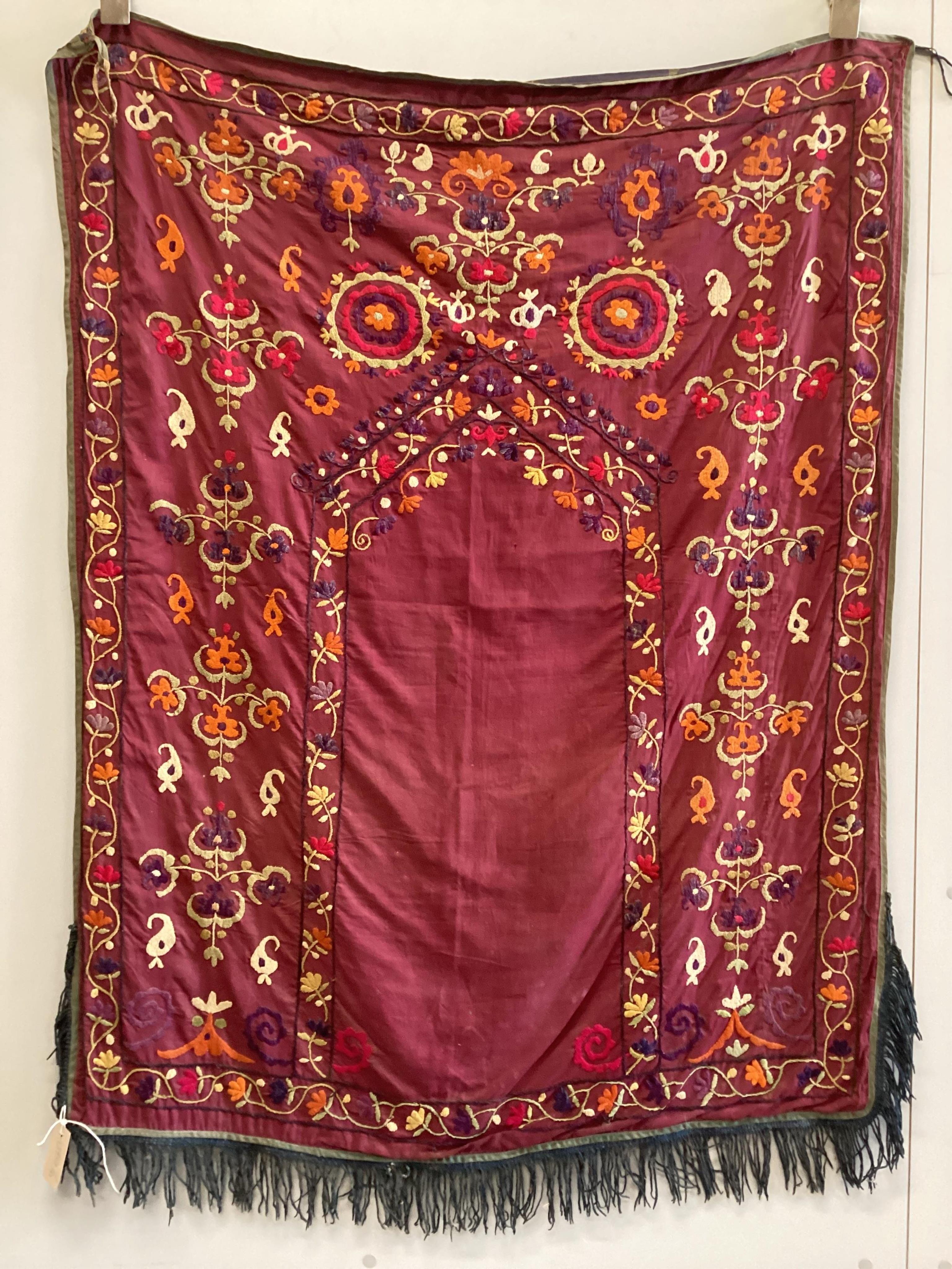 An early 20th century silk embroidered Uzbek Suzani, 120 x 92cm. Condition - fair